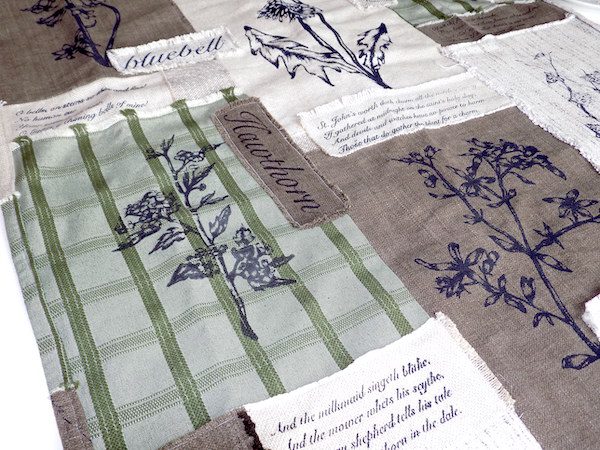 Screen-printed patchwork sample including floral imagery and written elements
