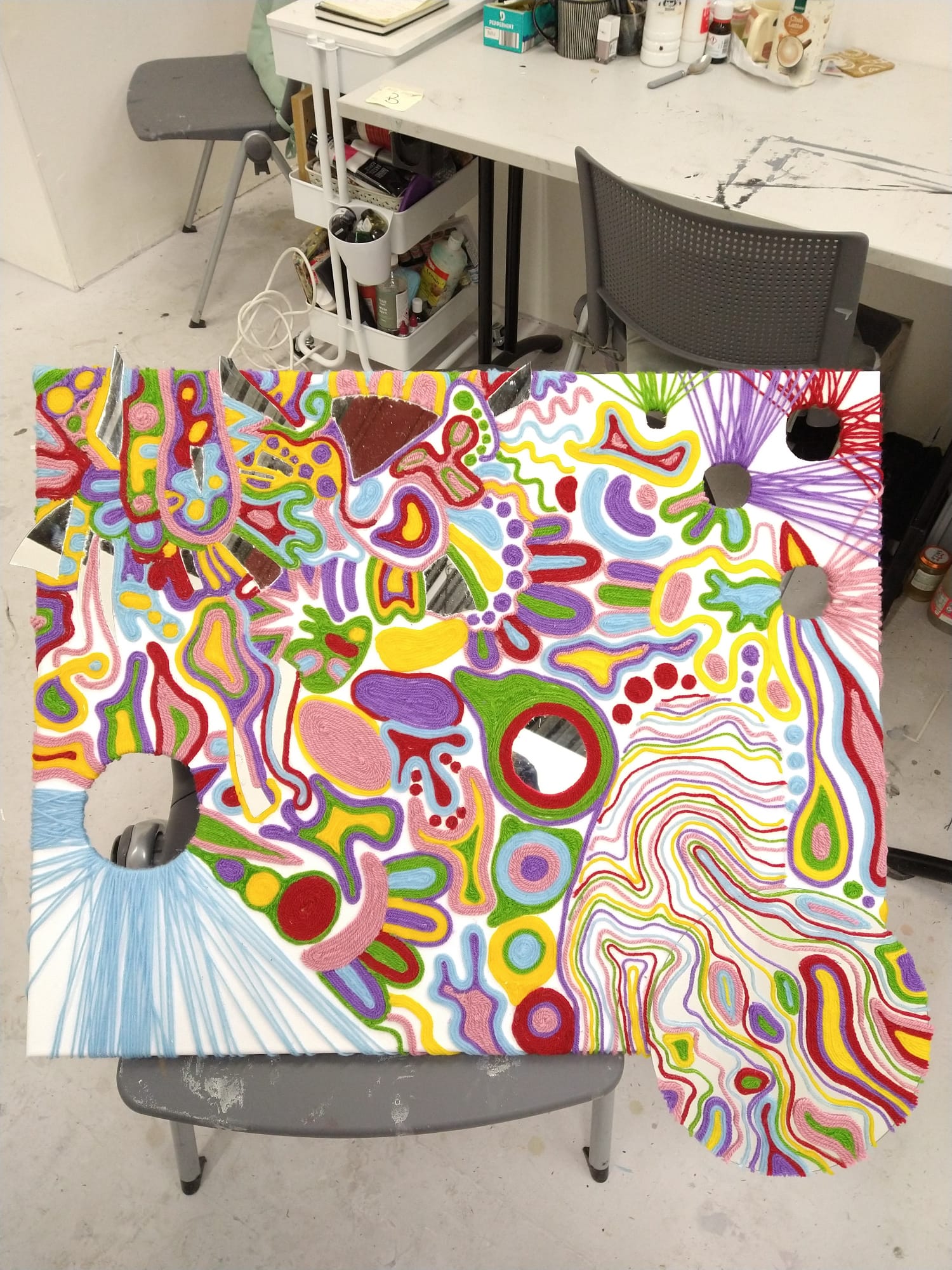 Shapes and colours glued onto a large scale canvas. Also between the shapes, mirrors and wholes.